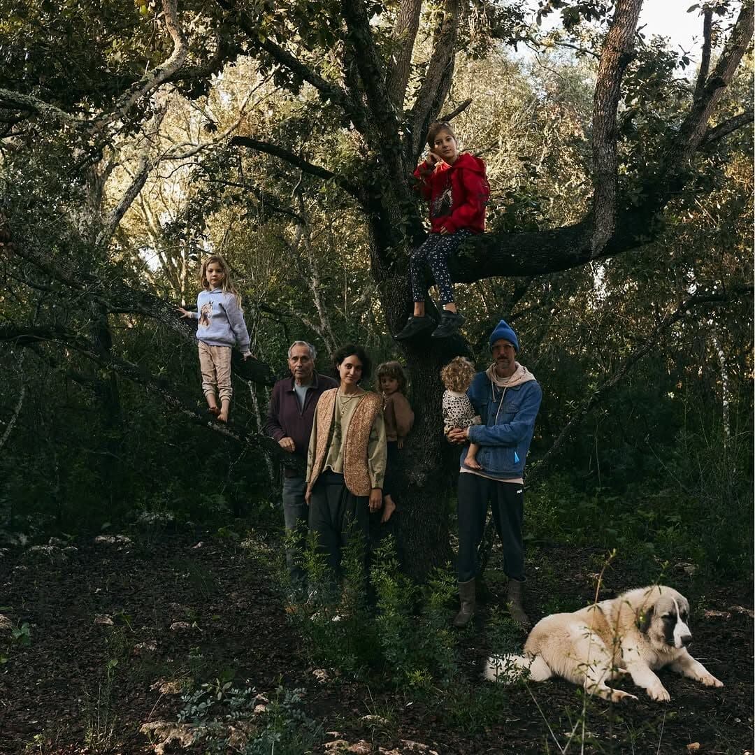 ema, tomas and their children in the mediterranean forest with the family dog